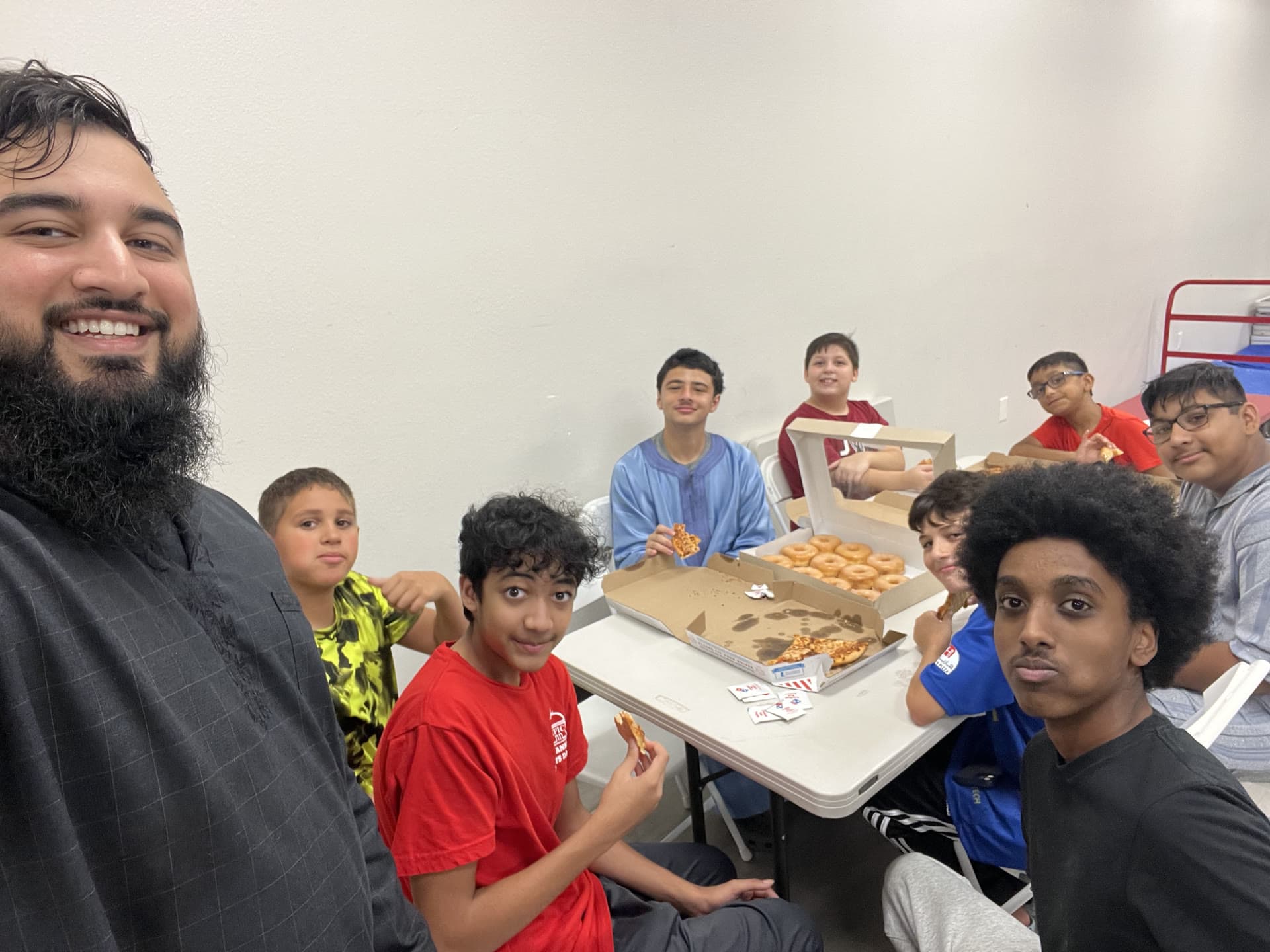 Ihsan Circle's founder sharing a meal with students at a table
