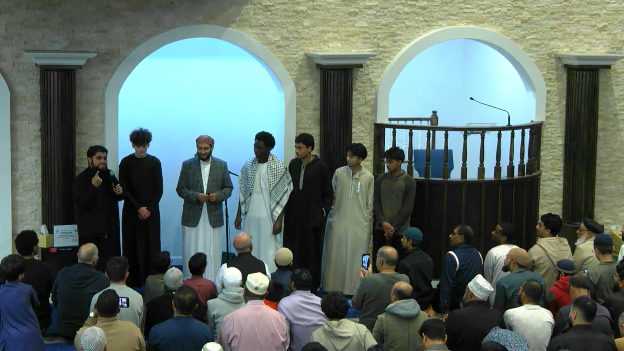New Muslims introduced to the congregation inside the masjid