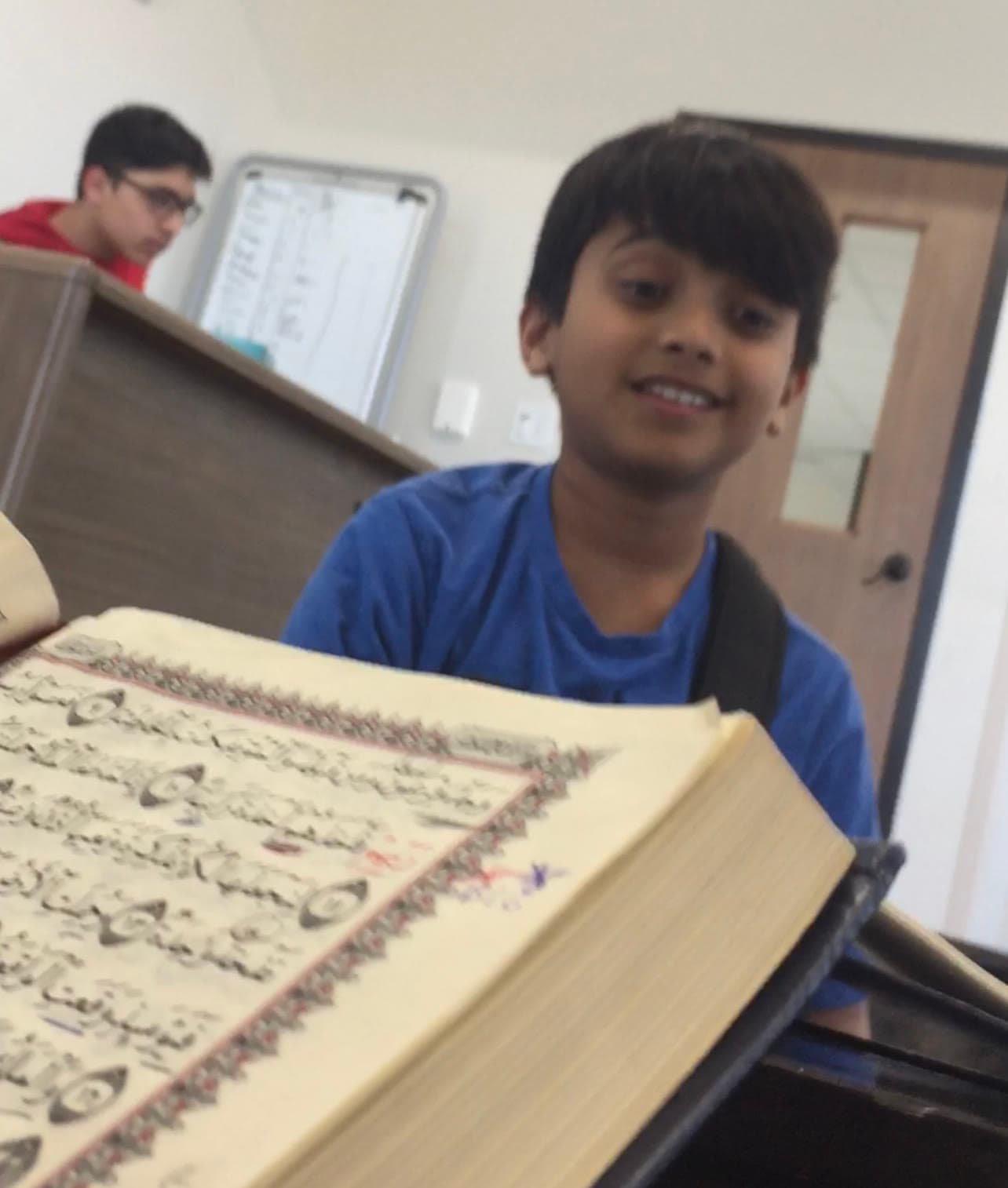 A young student reading from the Qur'an