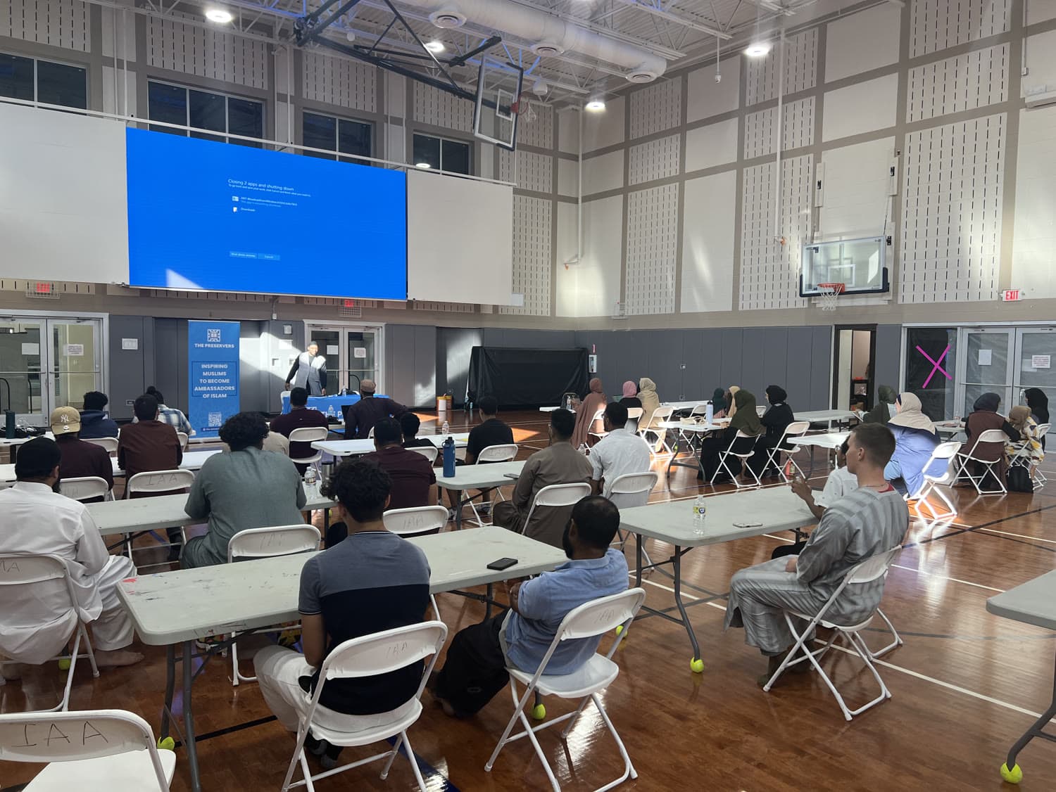 Attendees seated facing a presentation screen during a workshop