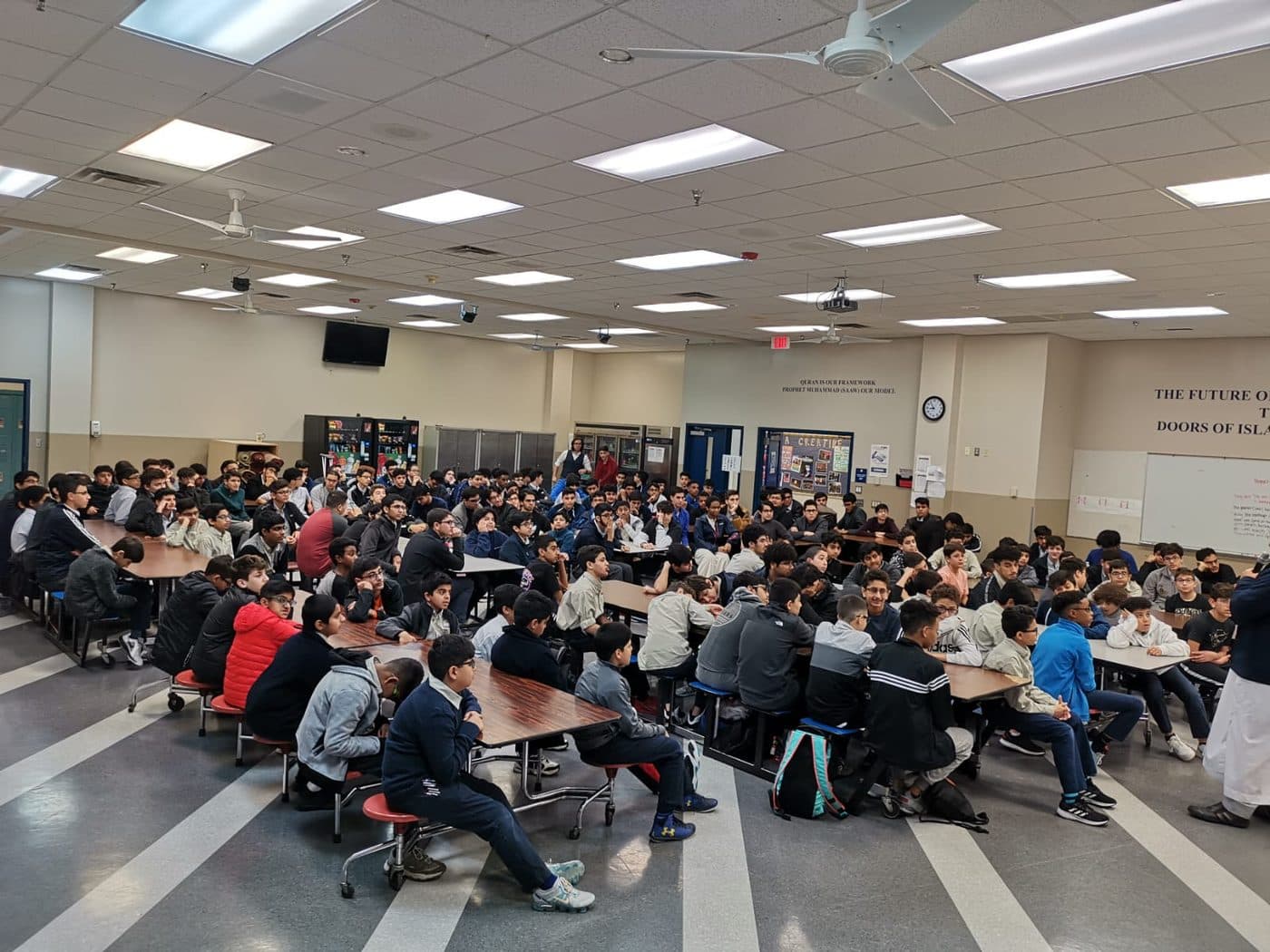 A packed youth program filling a school cafeteria in Garland