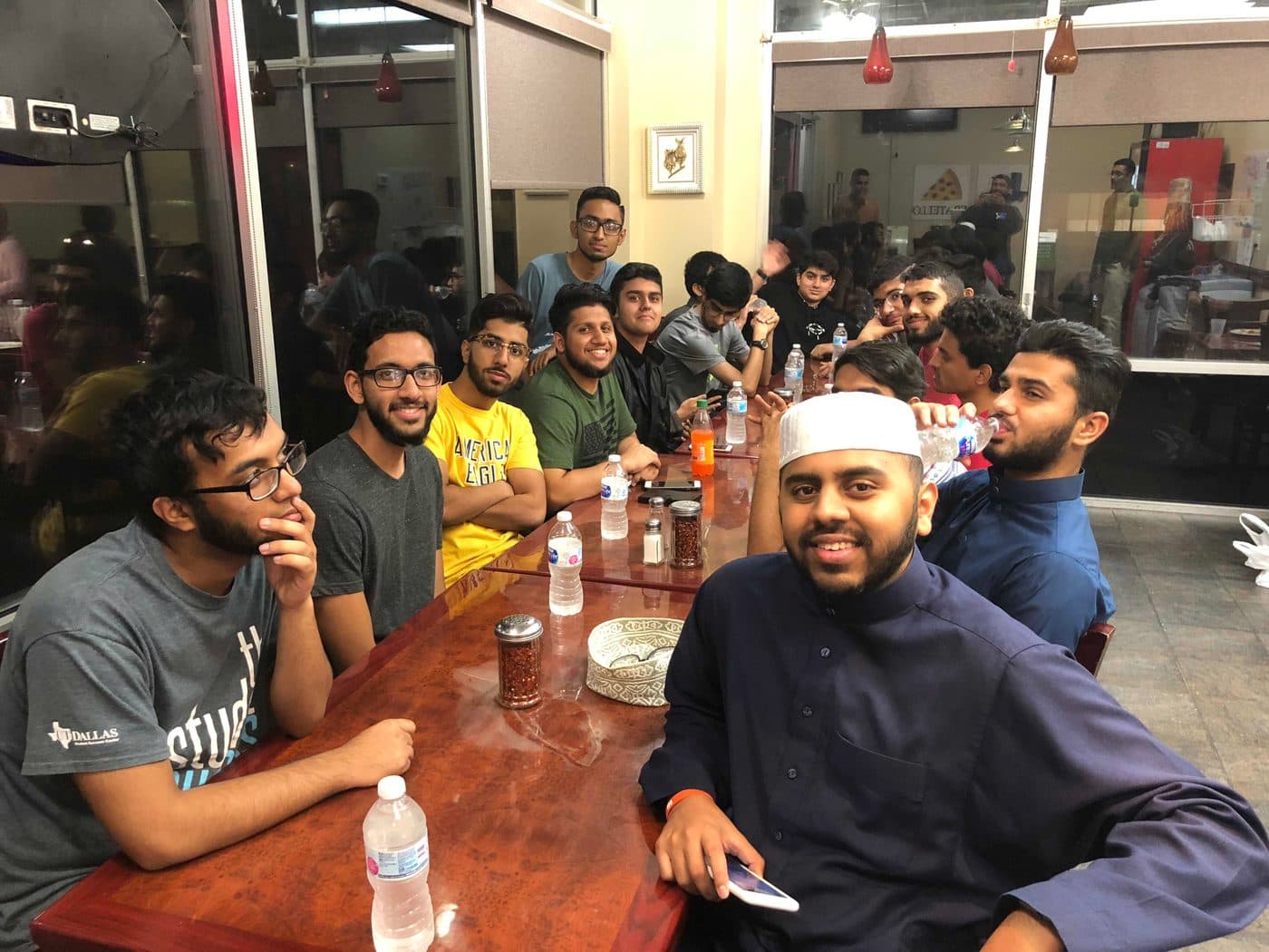 Students sharing a late-night meal together at a pizza shop