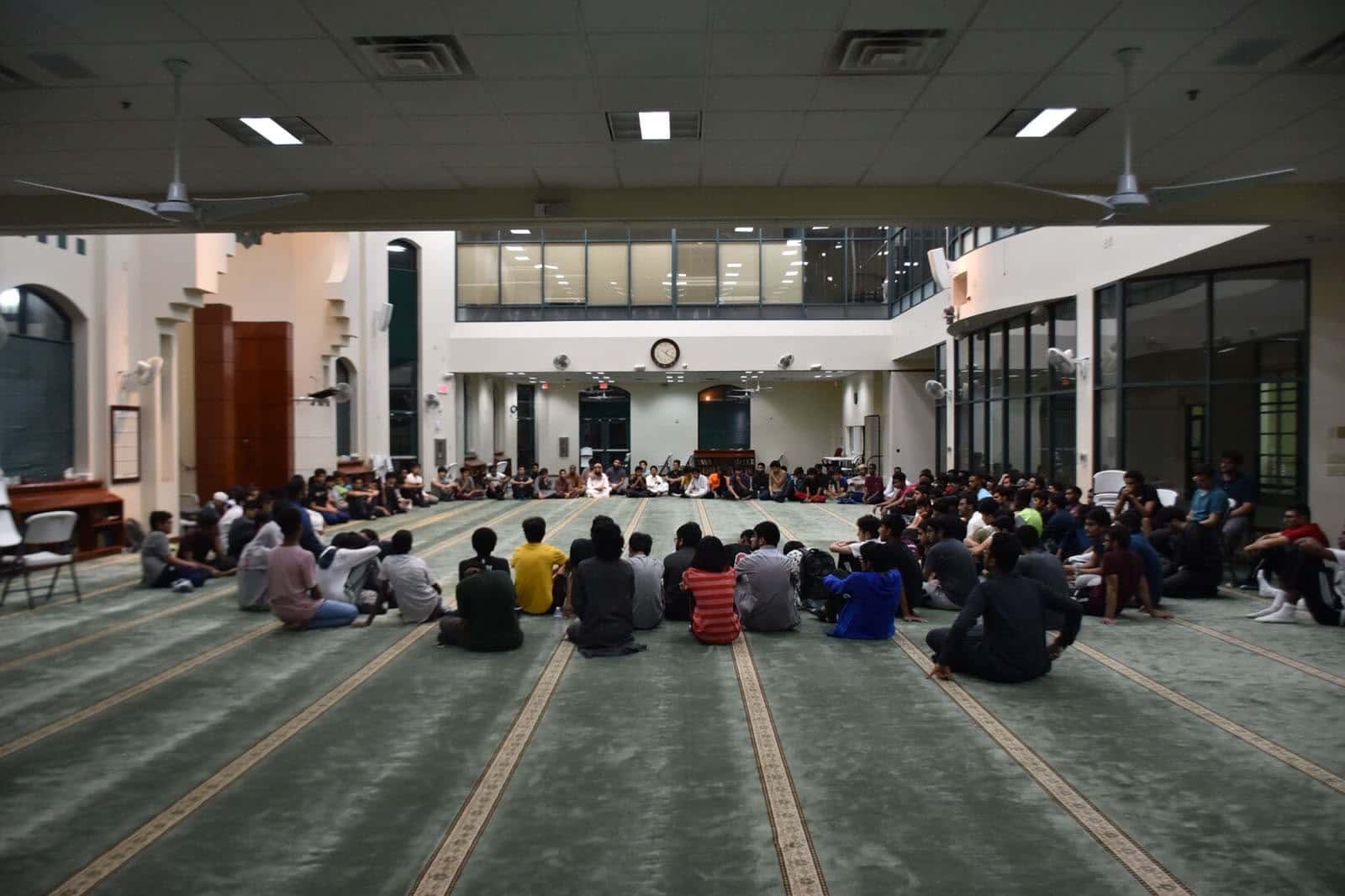 A masjid's whole youth in one great ring on the prayer hall floor