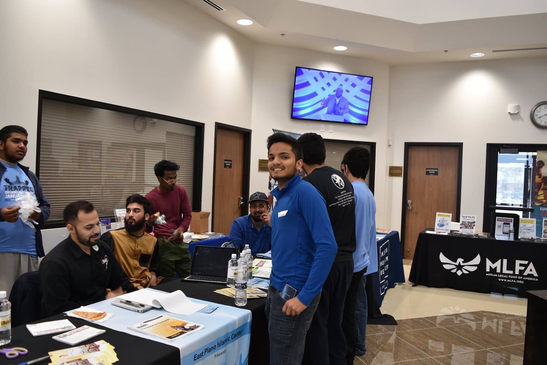 Irslan at a community outreach table event