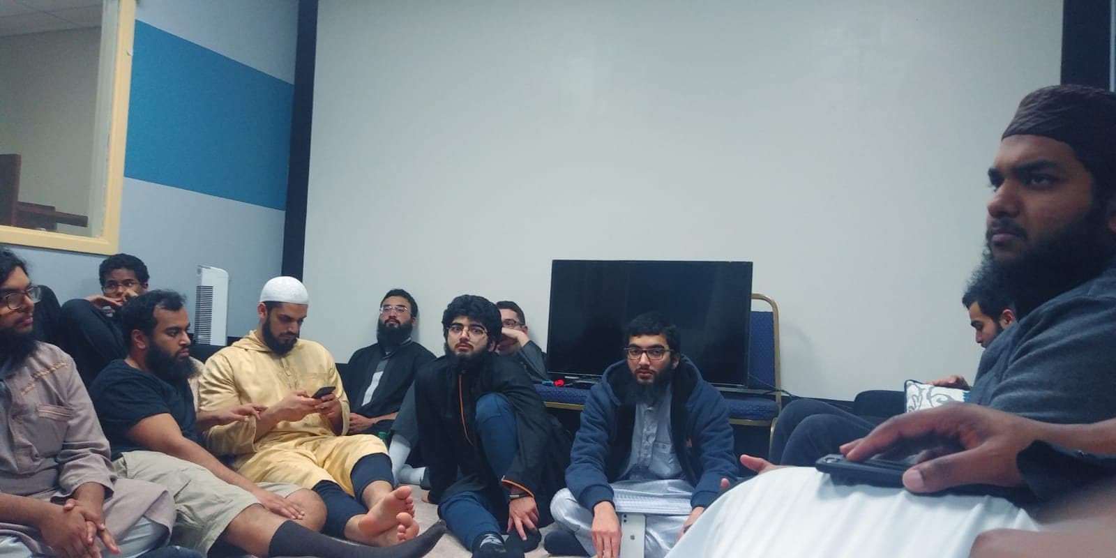 A study circle gathered around a presentation screen