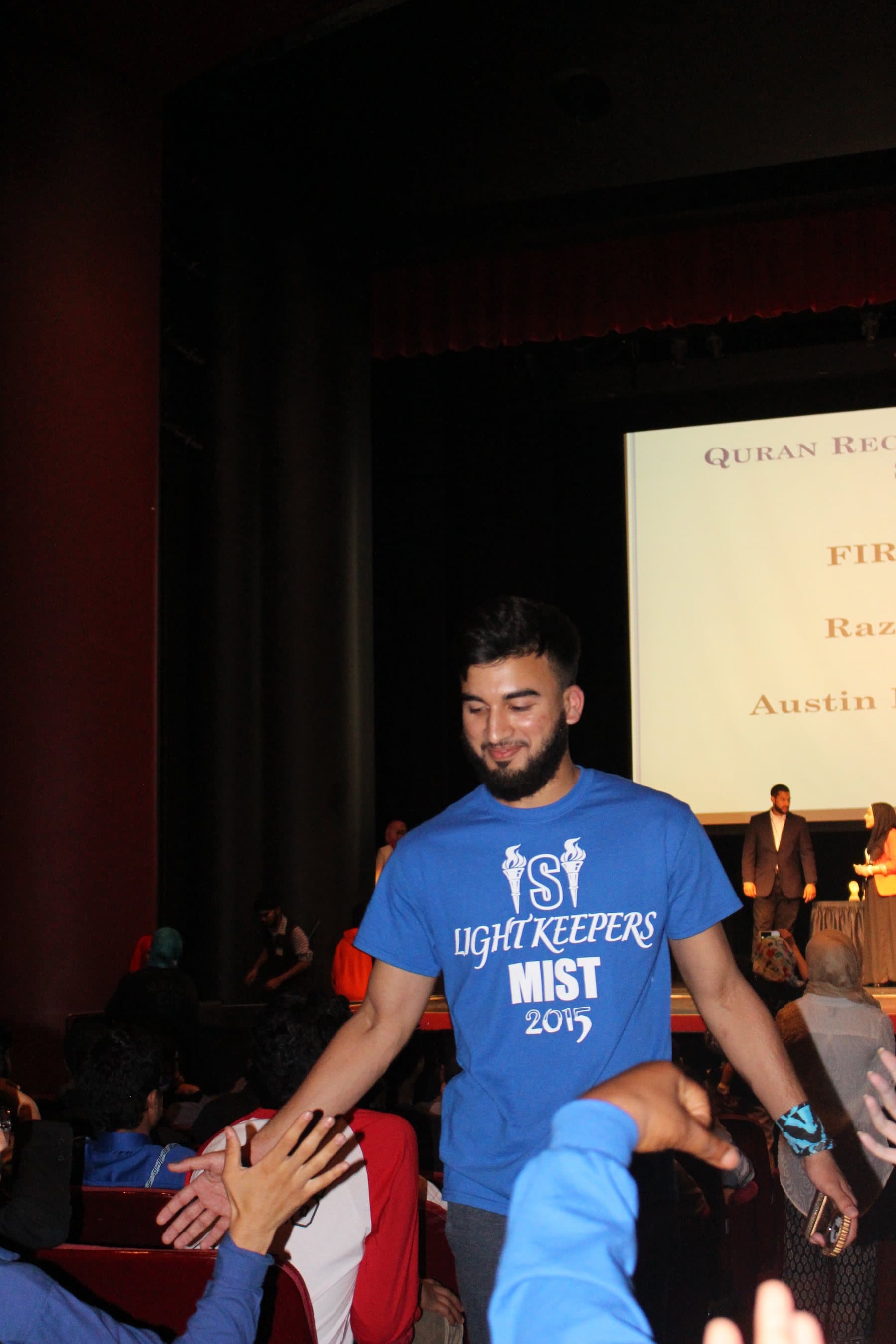 Irslan walking toward the stage at an Islamic School of Irving Qur'an competition