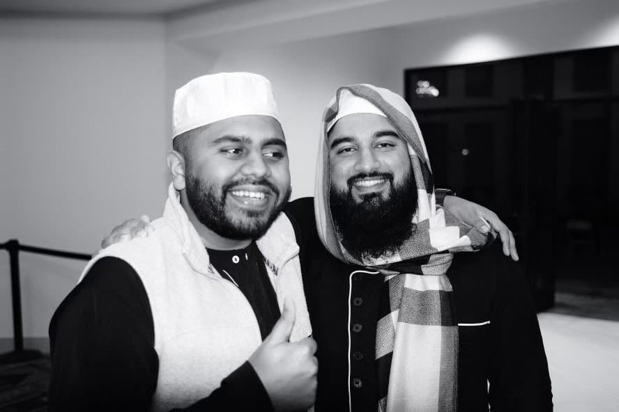 Irslan embracing a friend warmly, black and white portrait