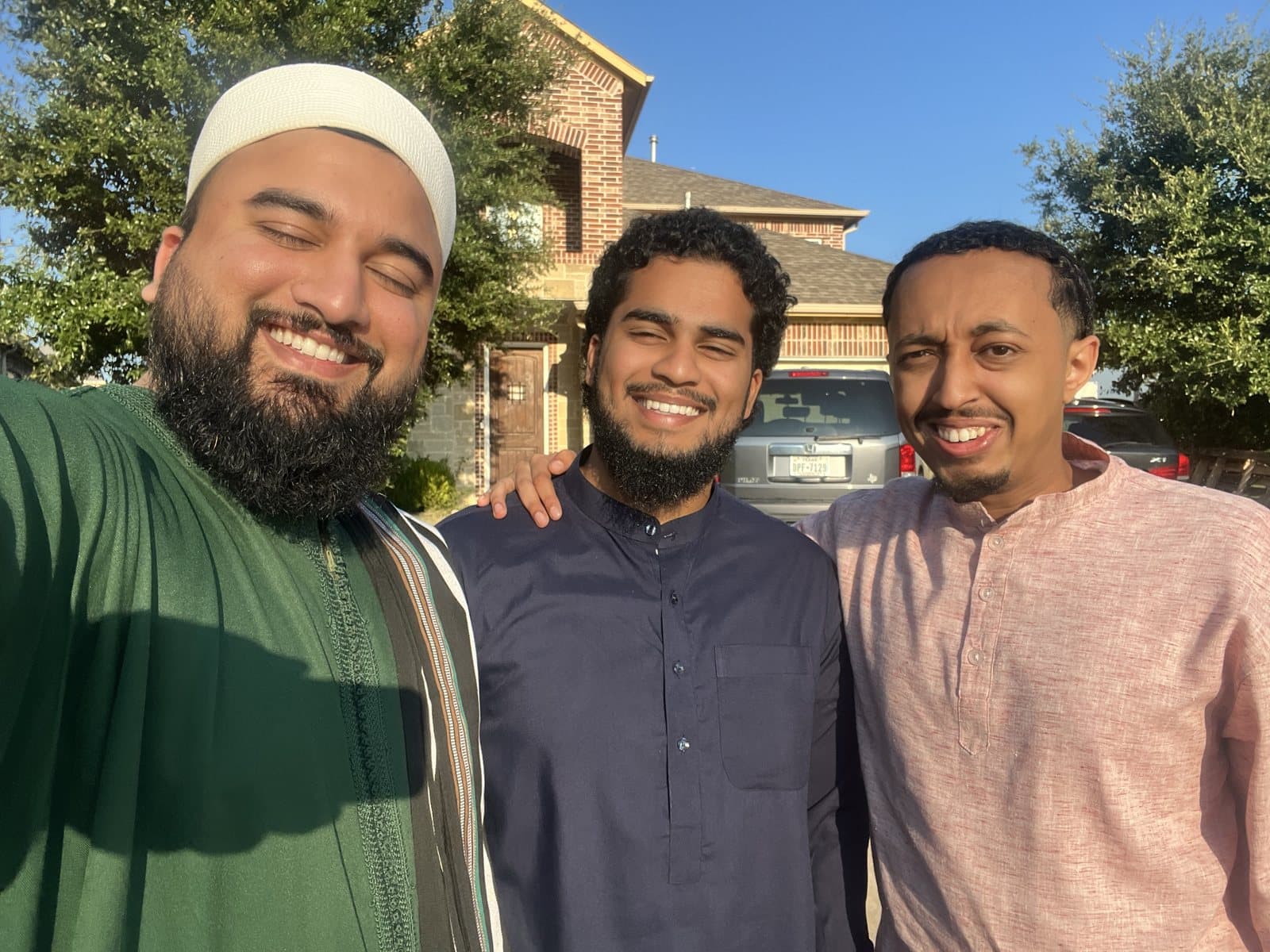 Irslan with two friends outside a home on a return visit
