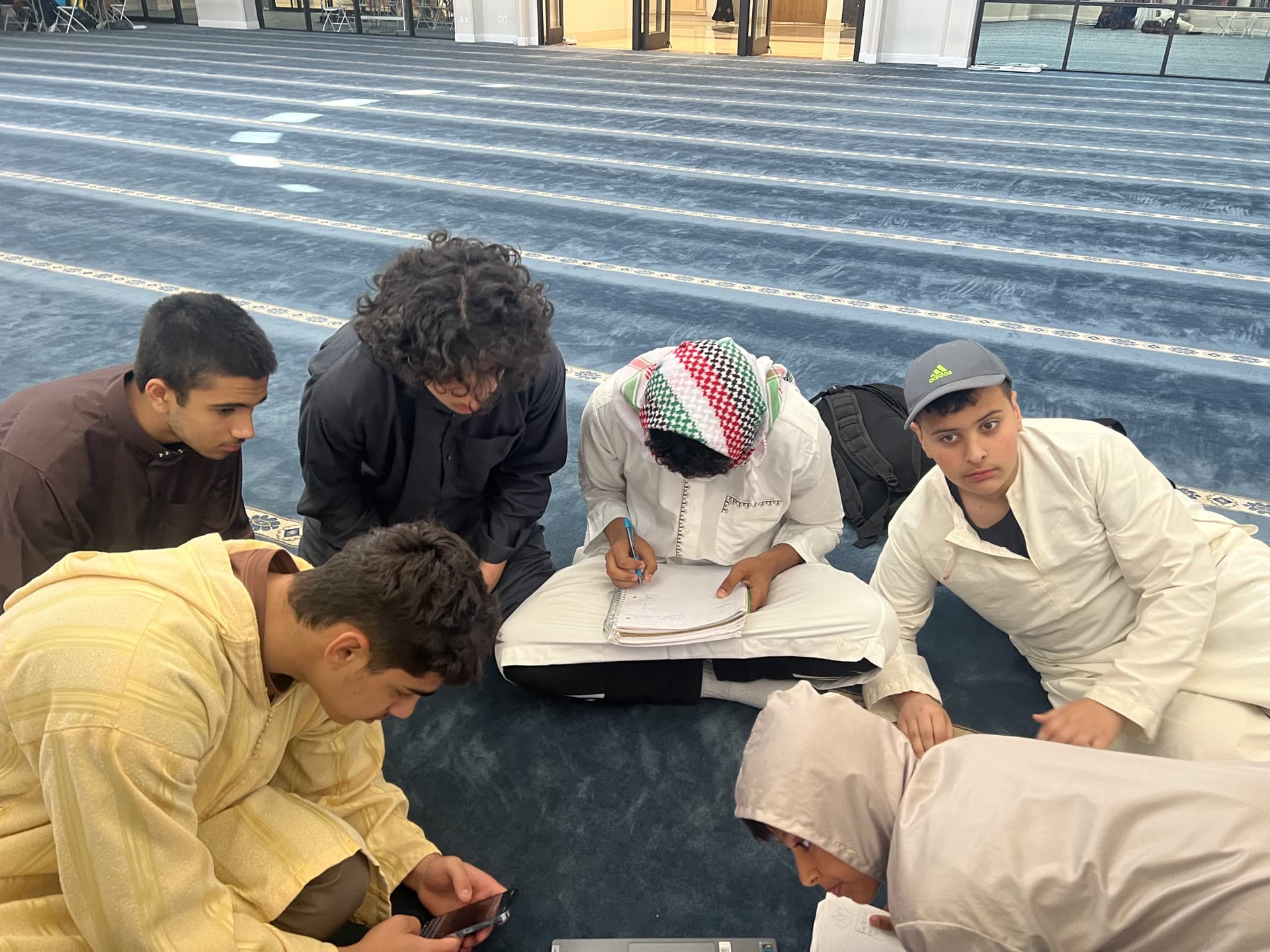Boys gathered in the summer, learning aqidah in person