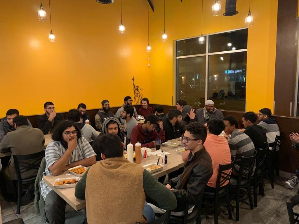 A halaqah that ends its night around one long dinner table
