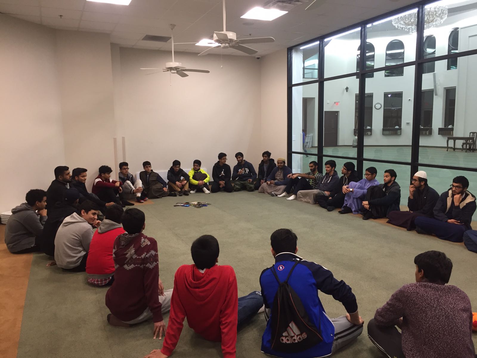 An evening circle grown wall to wall in the masjid annex
