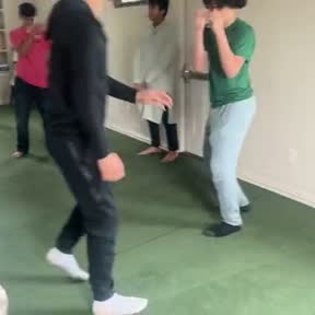 Students moving through a game in a masjid hall during a circle